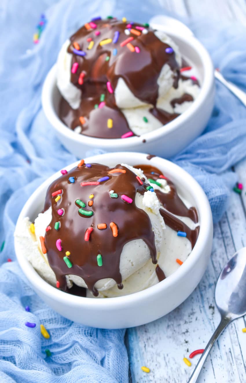 homemade magic shell recipe over scoops of vanilla ice cream in two small white bowls