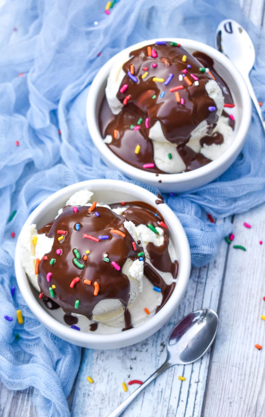 homemade magic shell recipe over scoops of vanilla ice cream in two small white bowls