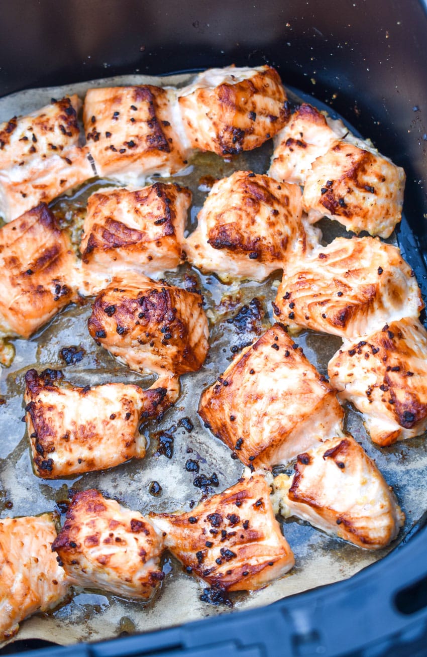 lemon garlic butter air fryer salmon bites in the basket of an air fryer