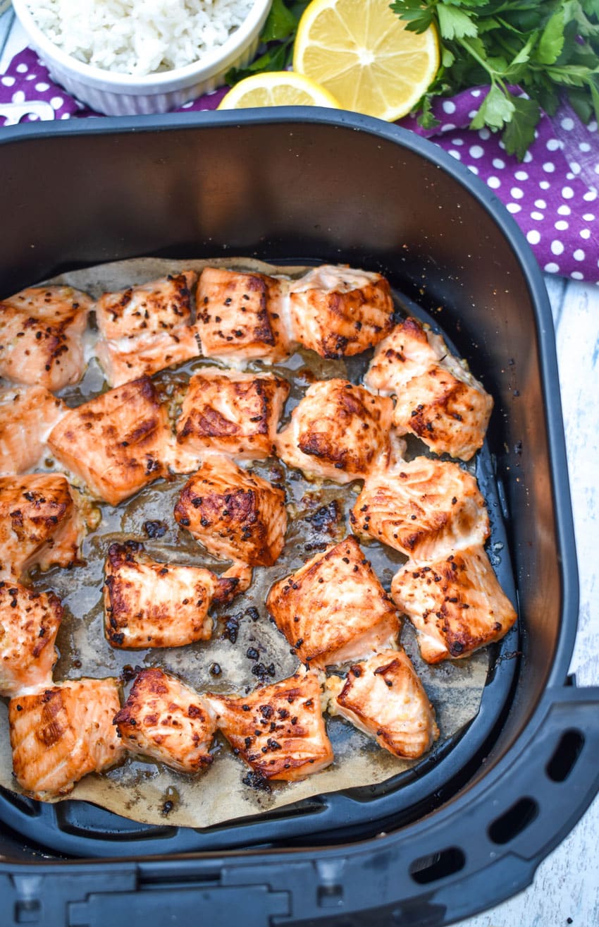 lemon garlic butter air fryer salmon bites in the basket of an air fryer
