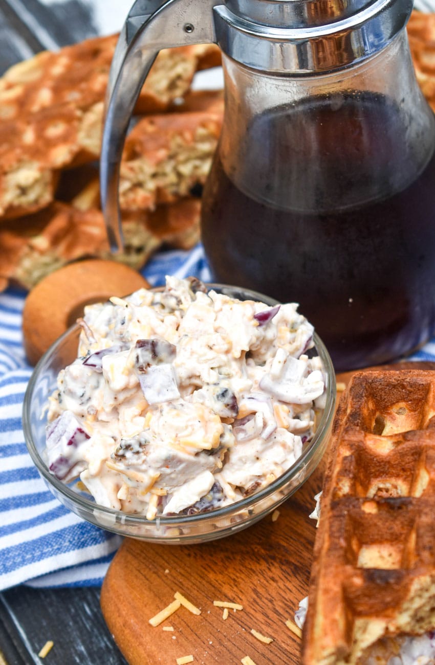 maple bacon chicken salad in a small glass bowl on a wooden cutting board