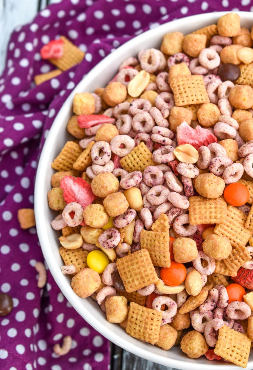 peanut butter and jelly trail mix in a white serving bowl
