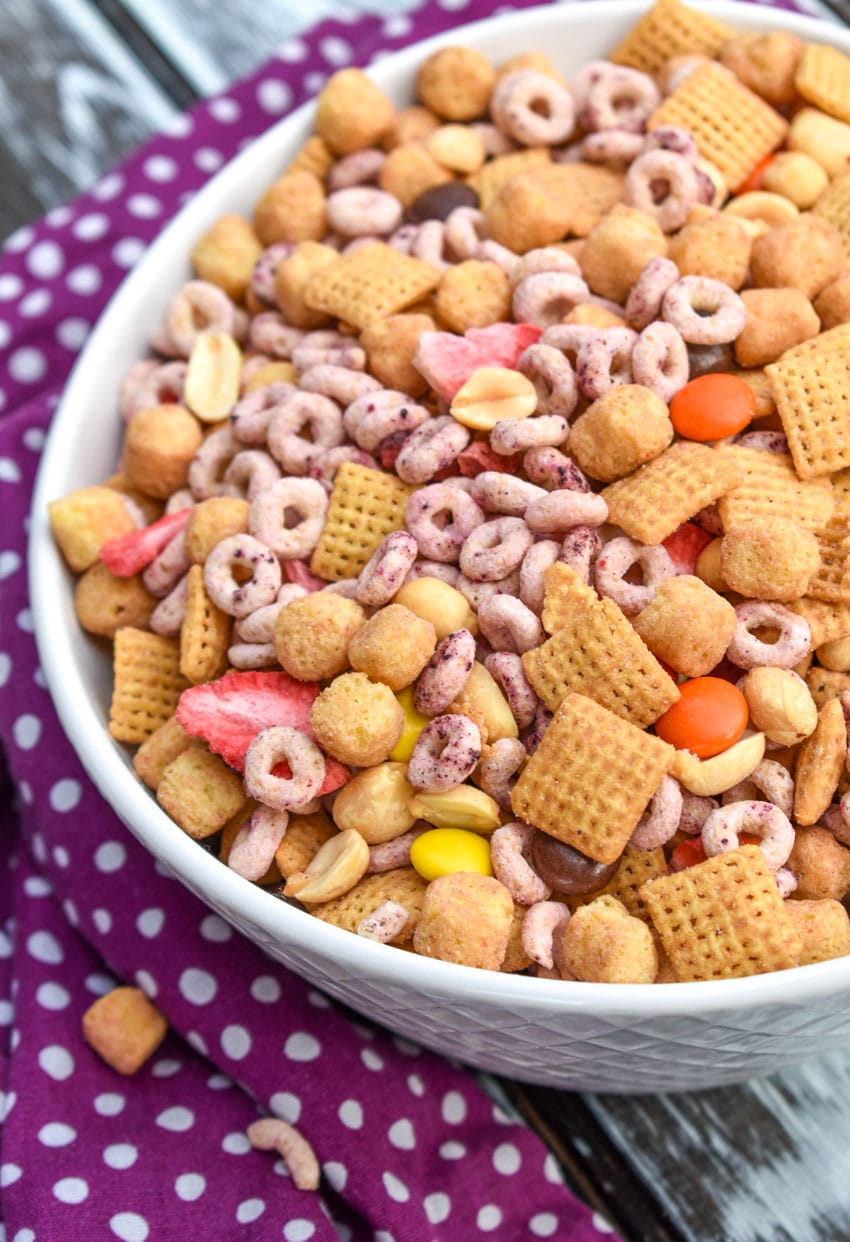 peanut butter and jelly trail mix in a white serving bowl