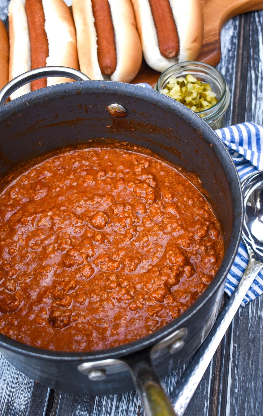 easy hot dog chili in a black pot on a wooden table