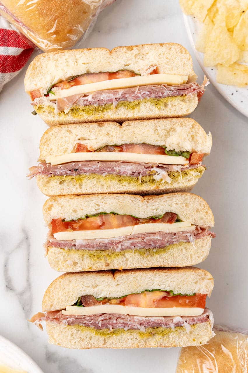 slices of an italian pressed picnic sandwich on a white countertop