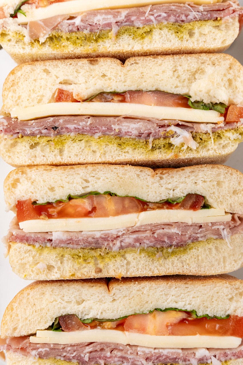 a close up of slices of italian pressed picnic sandwiches