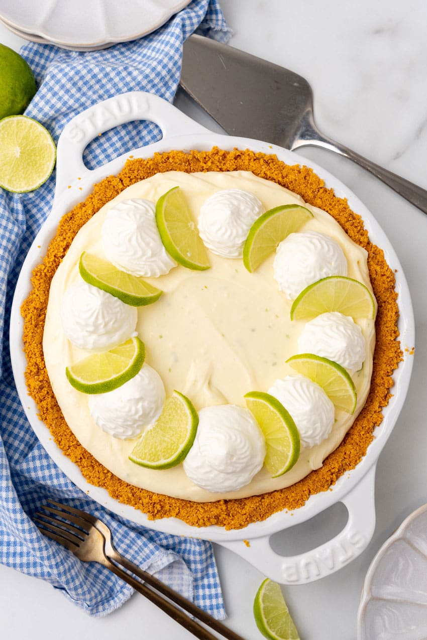 a no bake key lime pie cheesecake in a white pie dish