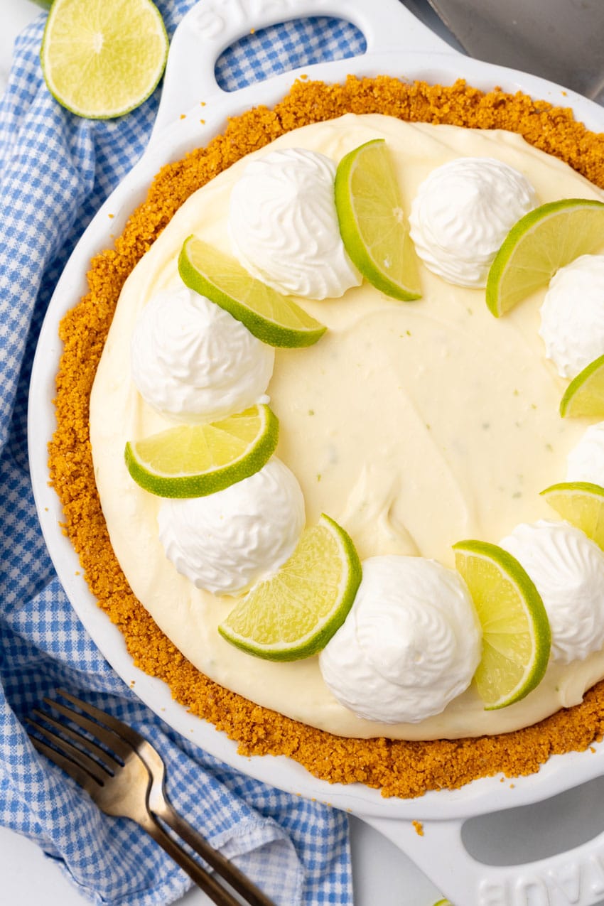 Easy Key Lime Pie (No Bake Recipe) a no bake key lime pie cheesecake in a white pie dish