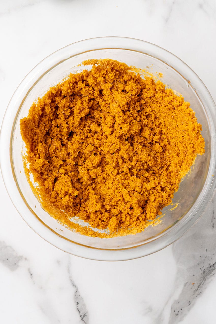 buttery graham cracker crumbs in a glass mixing bowl