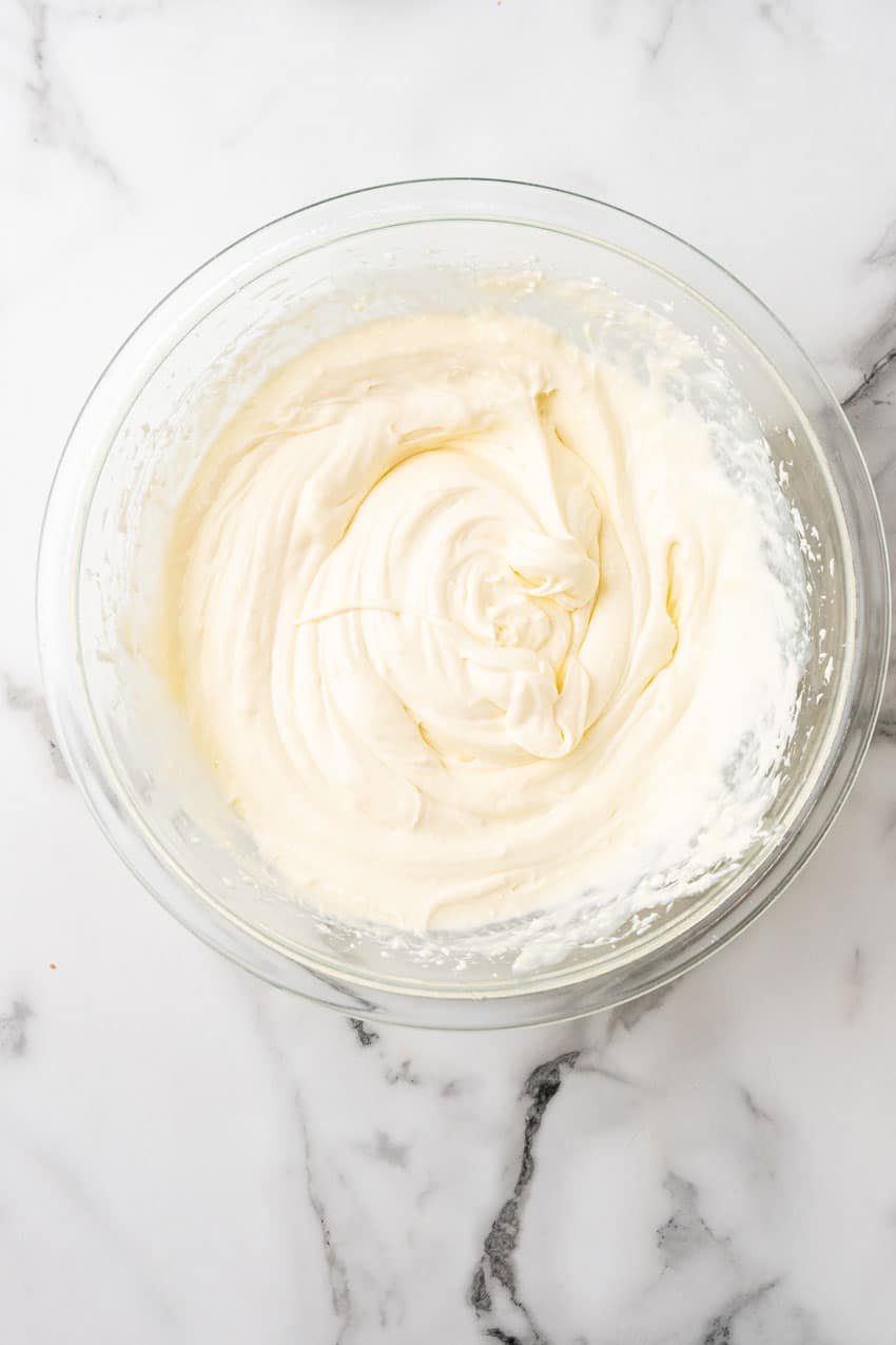 cream cheese cheesecake filling in a glass mixing bowl