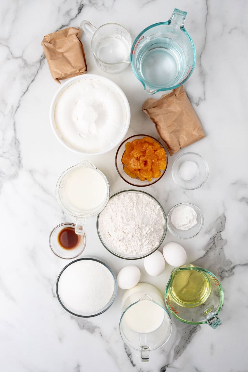 an overhead image showing the measured ingredients needed to make an orange creamsicle poke cake