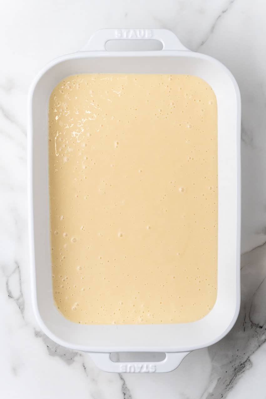 yellow cake batter in a white baking dish