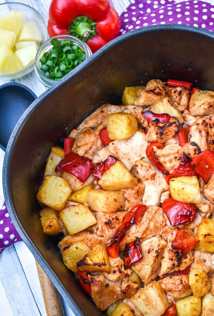 pineapple chicken in the basket of an air fryer