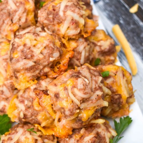 a pile of breakfast sausage balls on a white serving platter