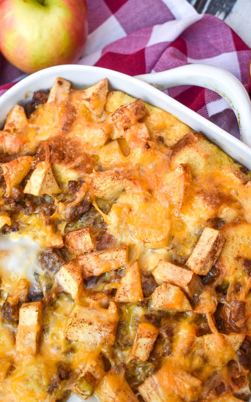 cheesy sausage apple breakfast bake in a white casserole dish