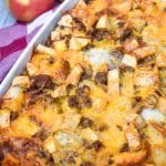 cheesy sausage apple breakfast bake in a white casserole dish