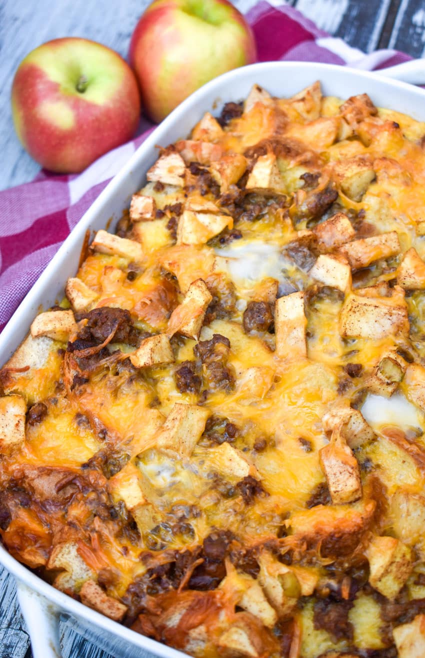 cheesy sausage apple breakfast bake in a white casserole dish