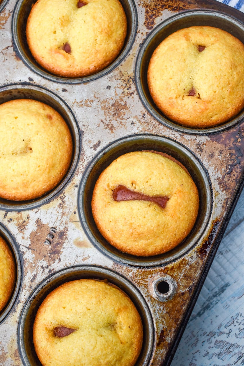 baked corn dog muffins in a metal muffin tin