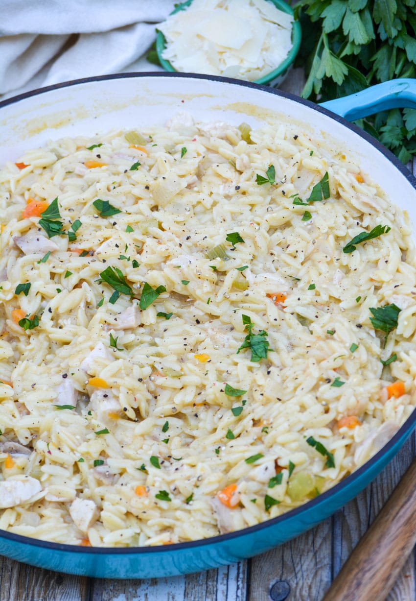creamy chicken and orzo pasta in a cast iron skillet
