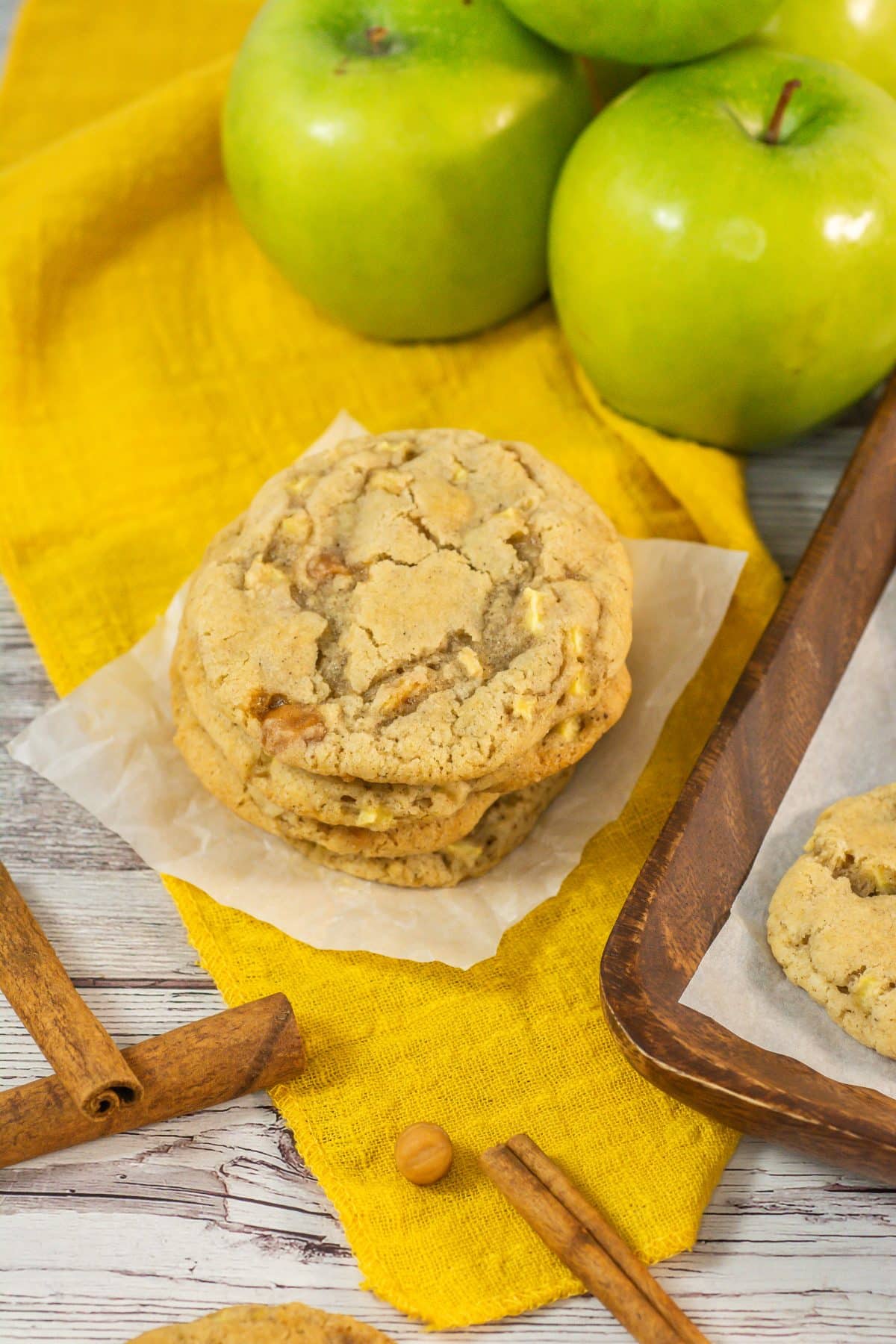 a stack of four caramel apple cookies on a small square of white parchment paper
