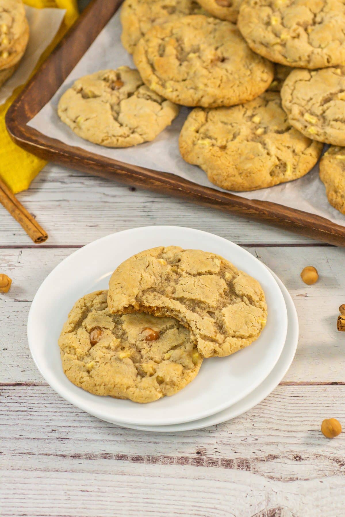 two caramel apple cookies on a small white dessert plate
