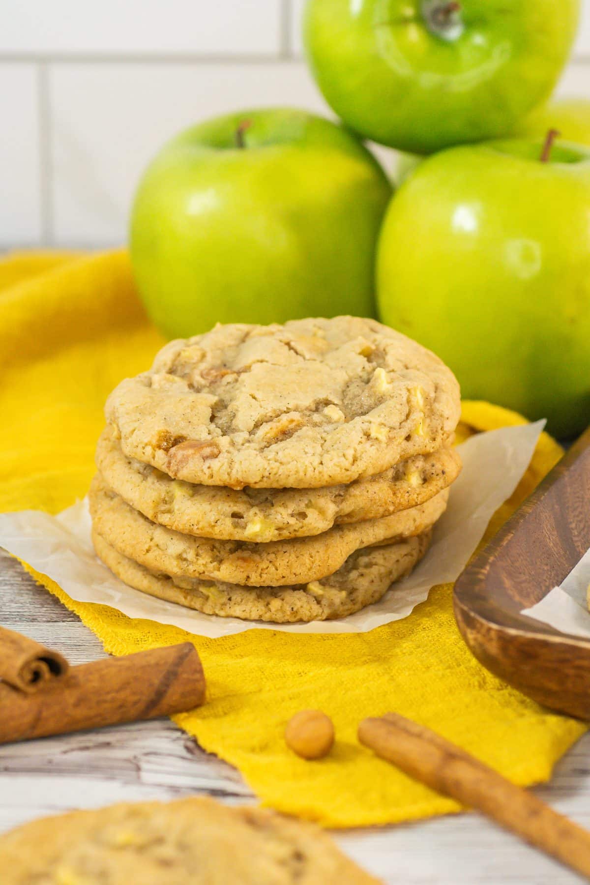 a stack of four caramel apple cookies on a small square of white parchment paper