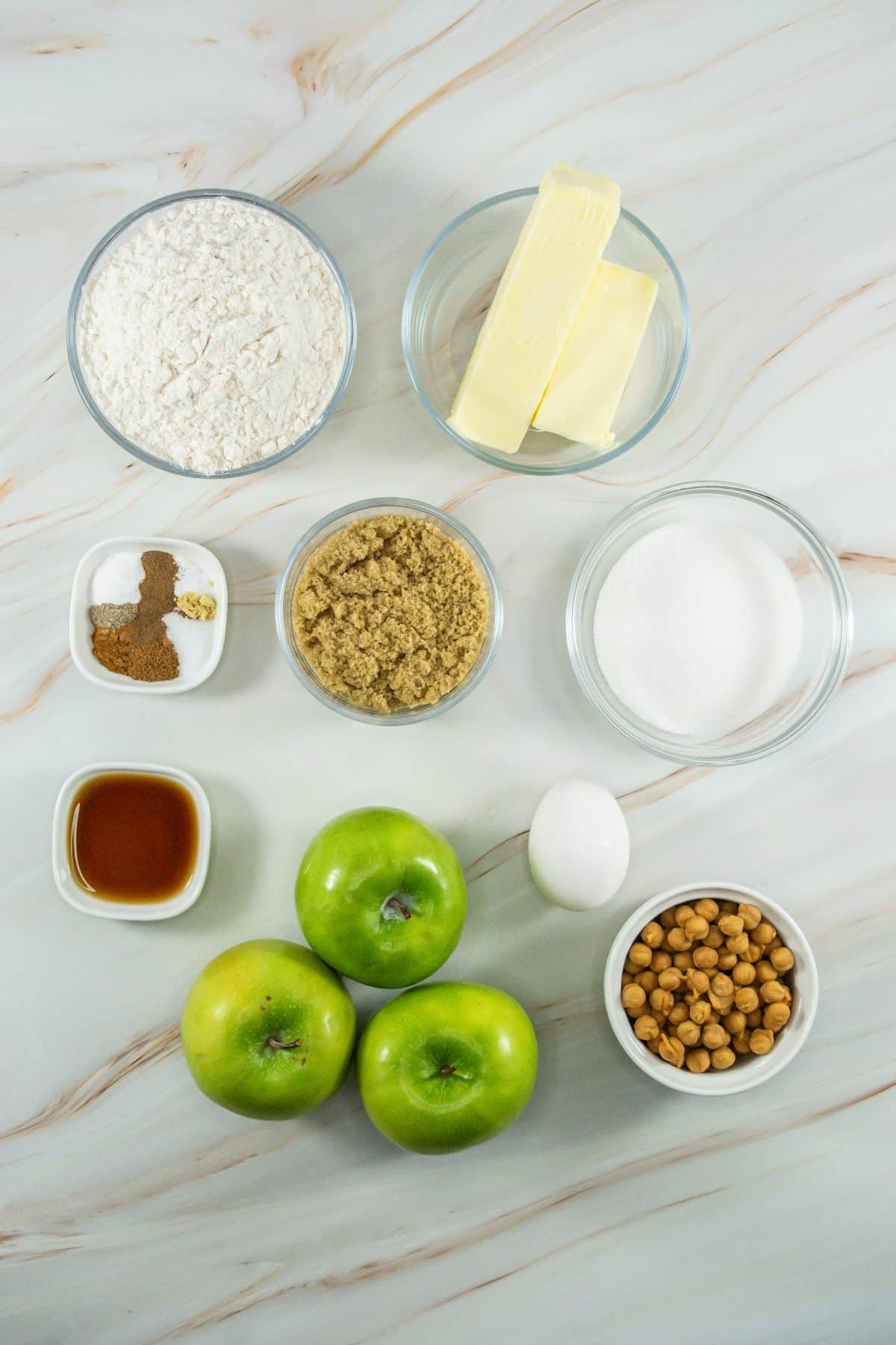 an overhead image showing the measured ingredients needed to make a batch of caramel apple cookies