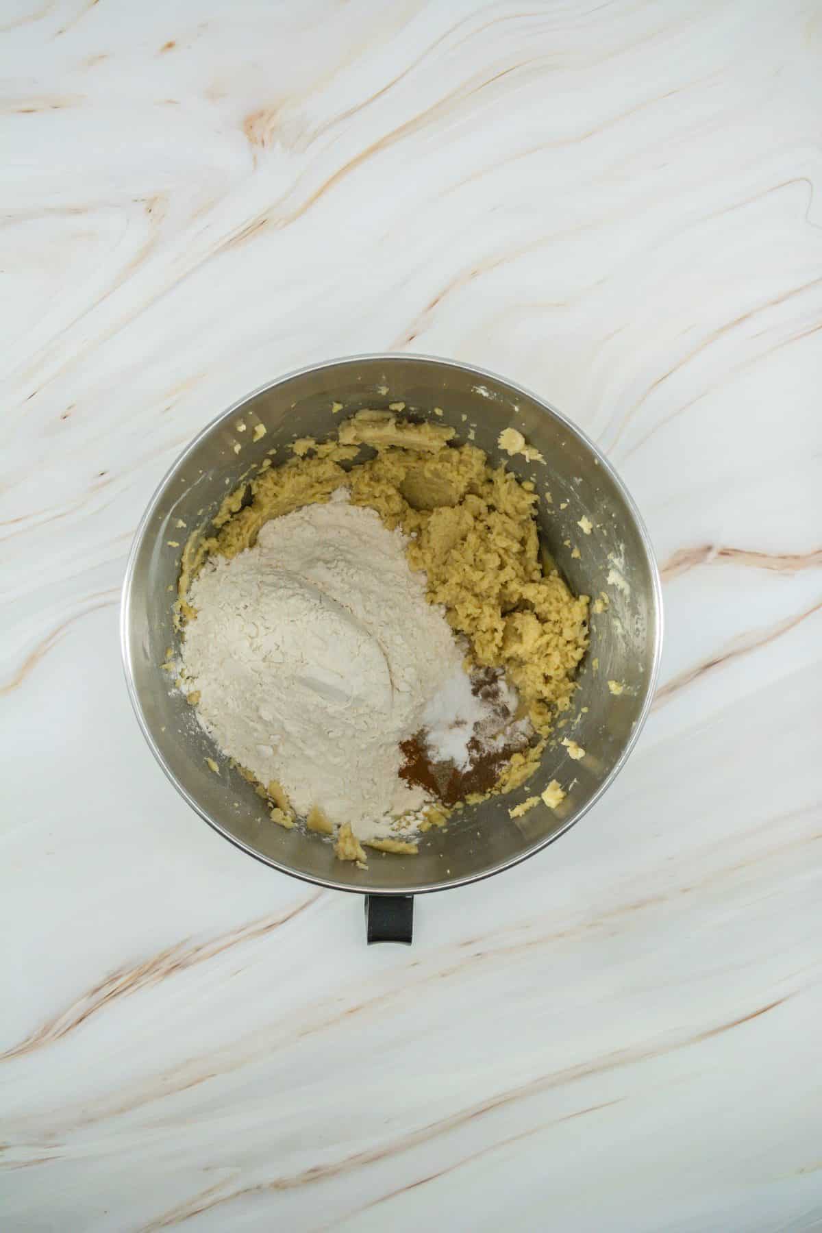caramel apple cookie batter in a metal mixing bowl