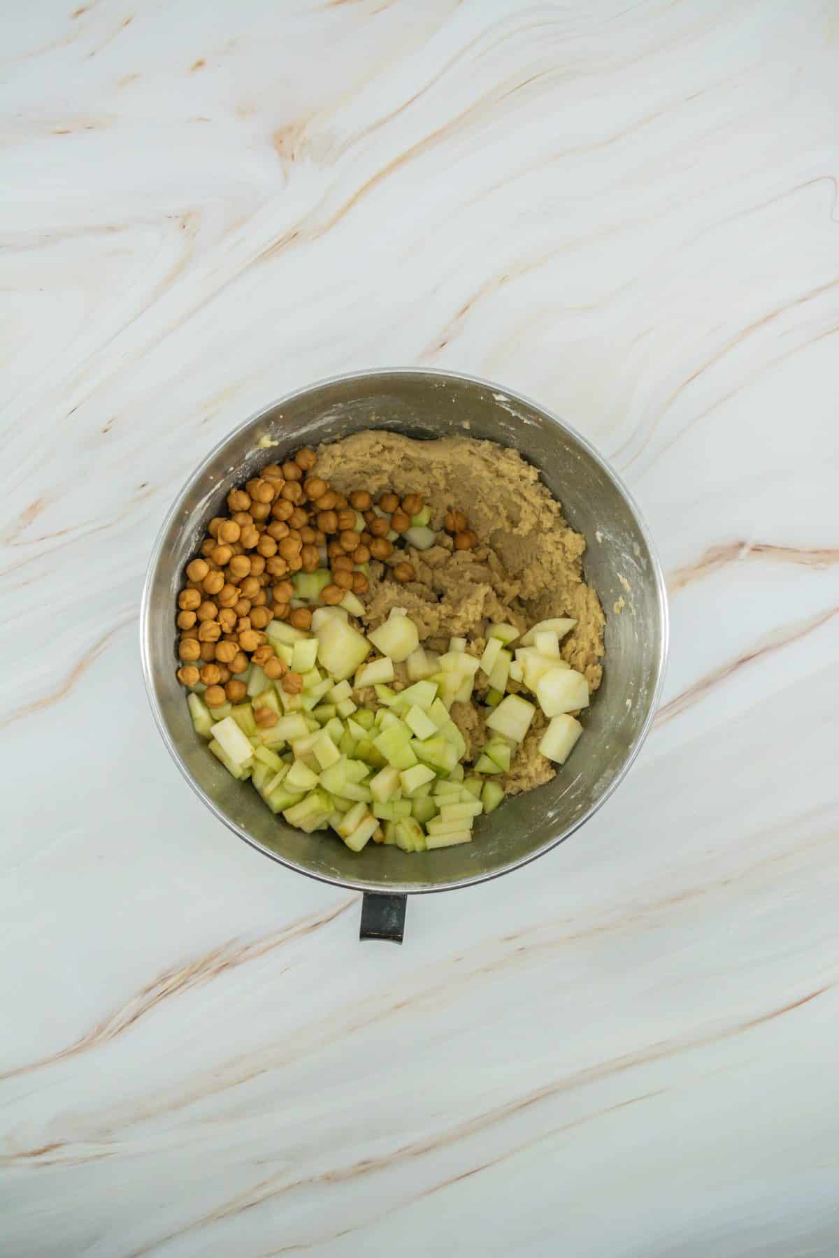 caramel apple cookie batter in a metal mixing bowl