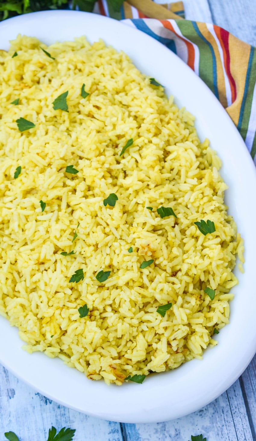 instant pot yellow rice in a white serving dish
