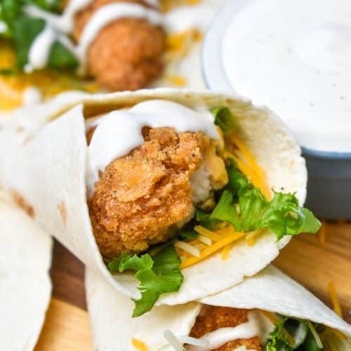 mcdonald's copycat chicken snack wraps stacked on a wooden cutting board