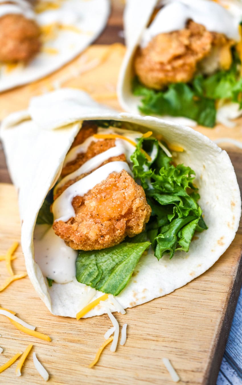 mcdonald's copycat chicken snack wraps resting on a wooden cutting board
