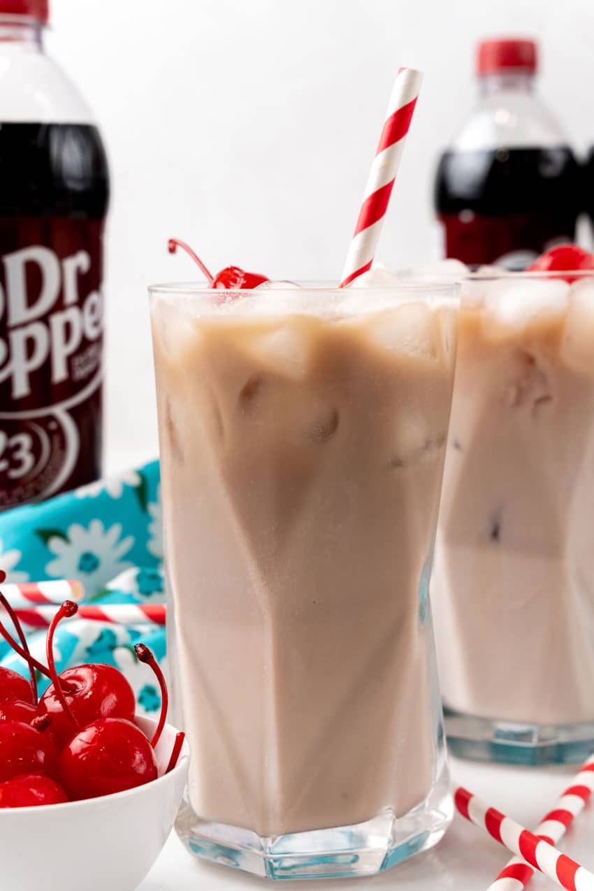 dirty soda recipe in a glass jar with a paper straw