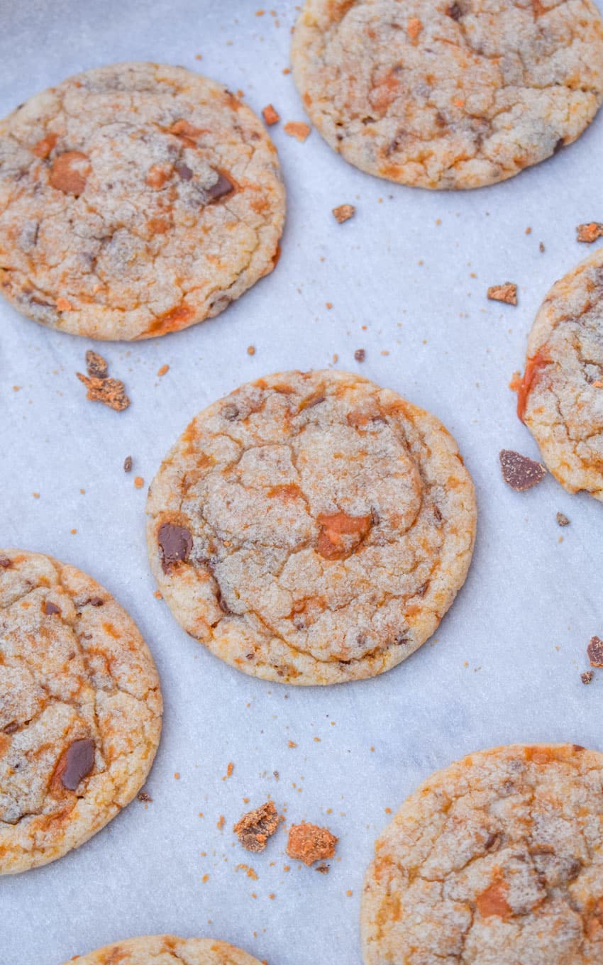 butterfinger cookies on a parchment paper lined baking sheet