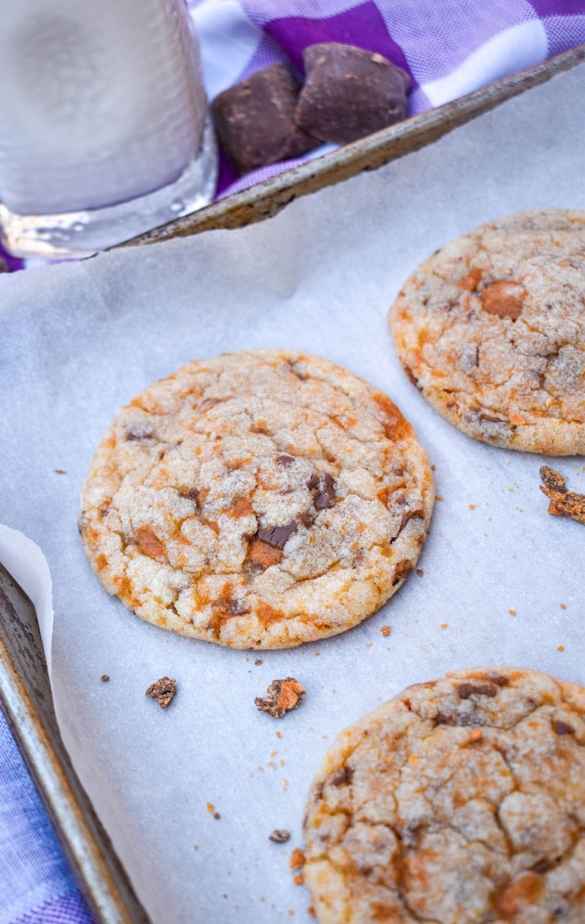 butterfinger cookies on a parchment paper lined baking sheet