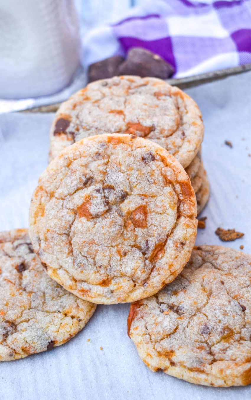butterfinger cookies on a parchment paper lined baking sheet