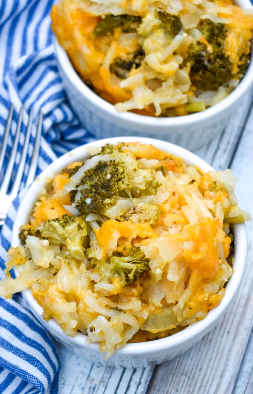 cheesy broccoli potato casserole in two small white ramekins