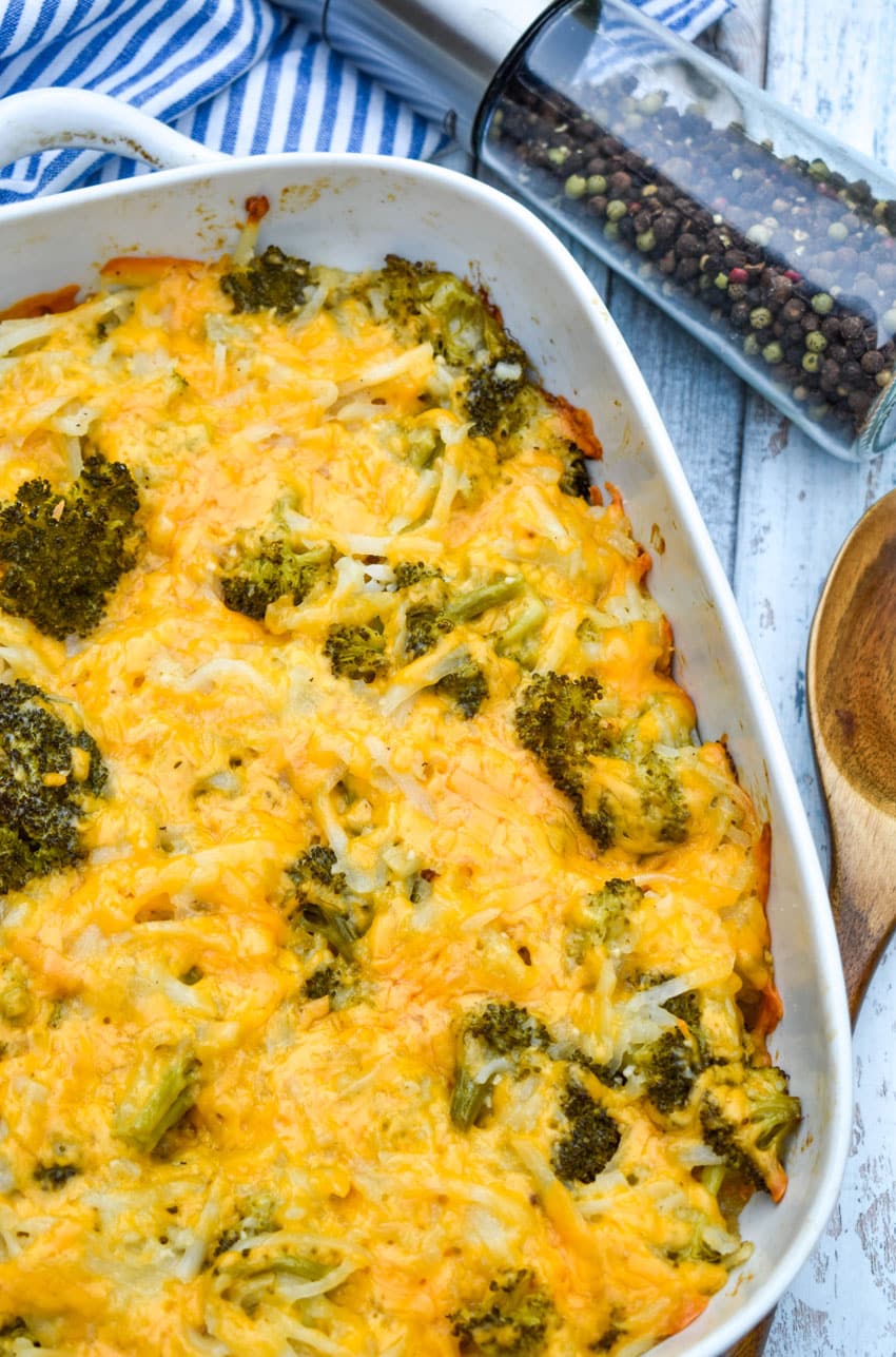 cheesy broccoli potato casserole in a white baking dish