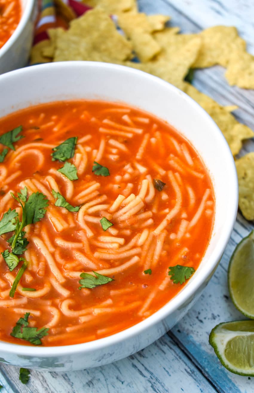 instant pot sopa de fideo topped with fresh cilantro leaves in two white soup bowls