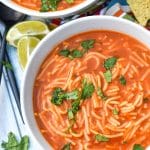 instant pot sopa de fideo topped with fresh cilantro leaves in two white soup bowls