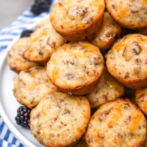 a stack of mcgriddle bites on a white plate with fresh blackberries on the side