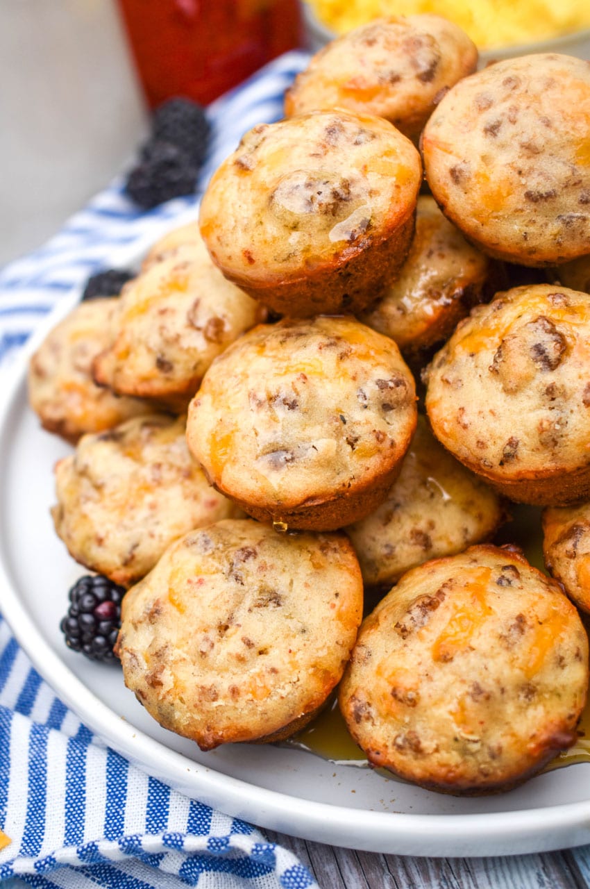 a stack of mcgriddle bites on a white plate with fresh blackberries on the side