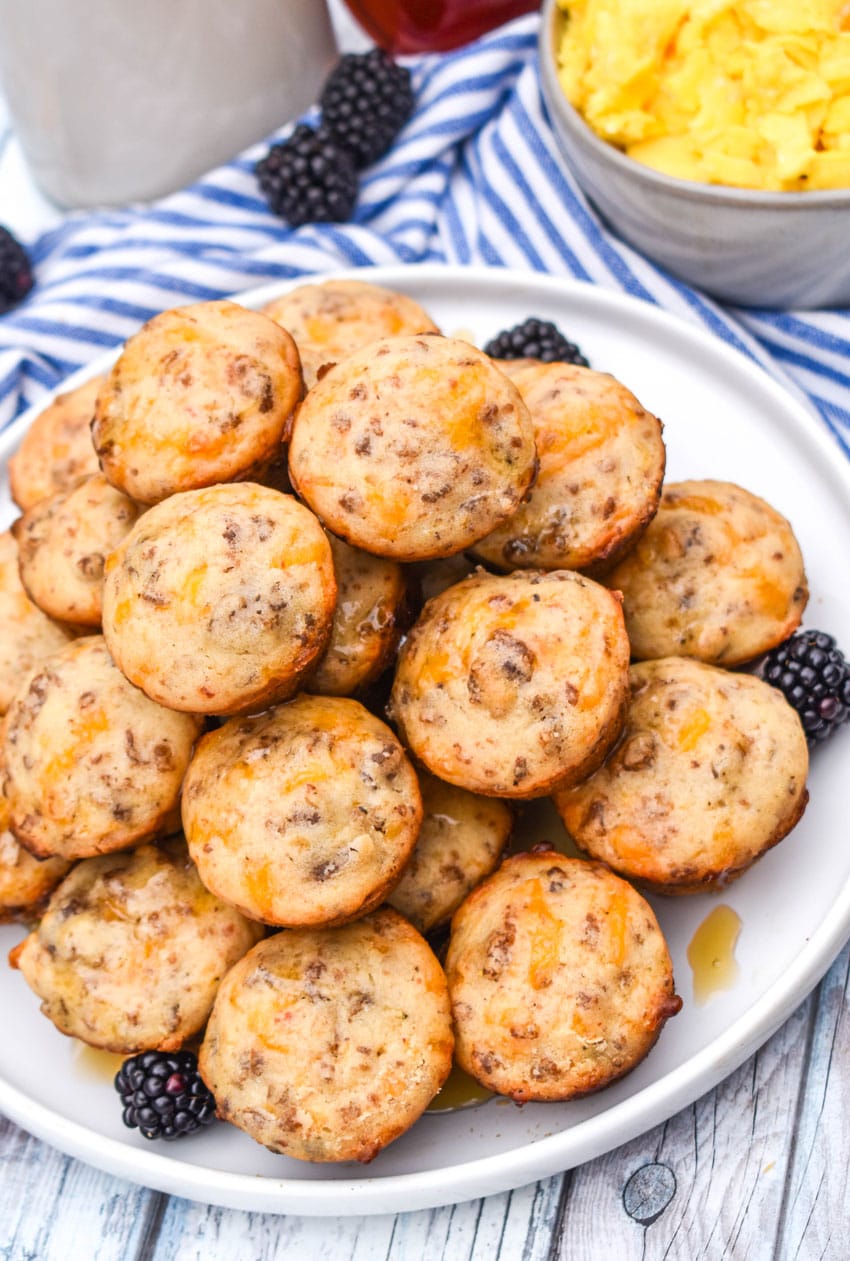 a stack of mcgriddle bites on a white plate with fresh blackberries on the side