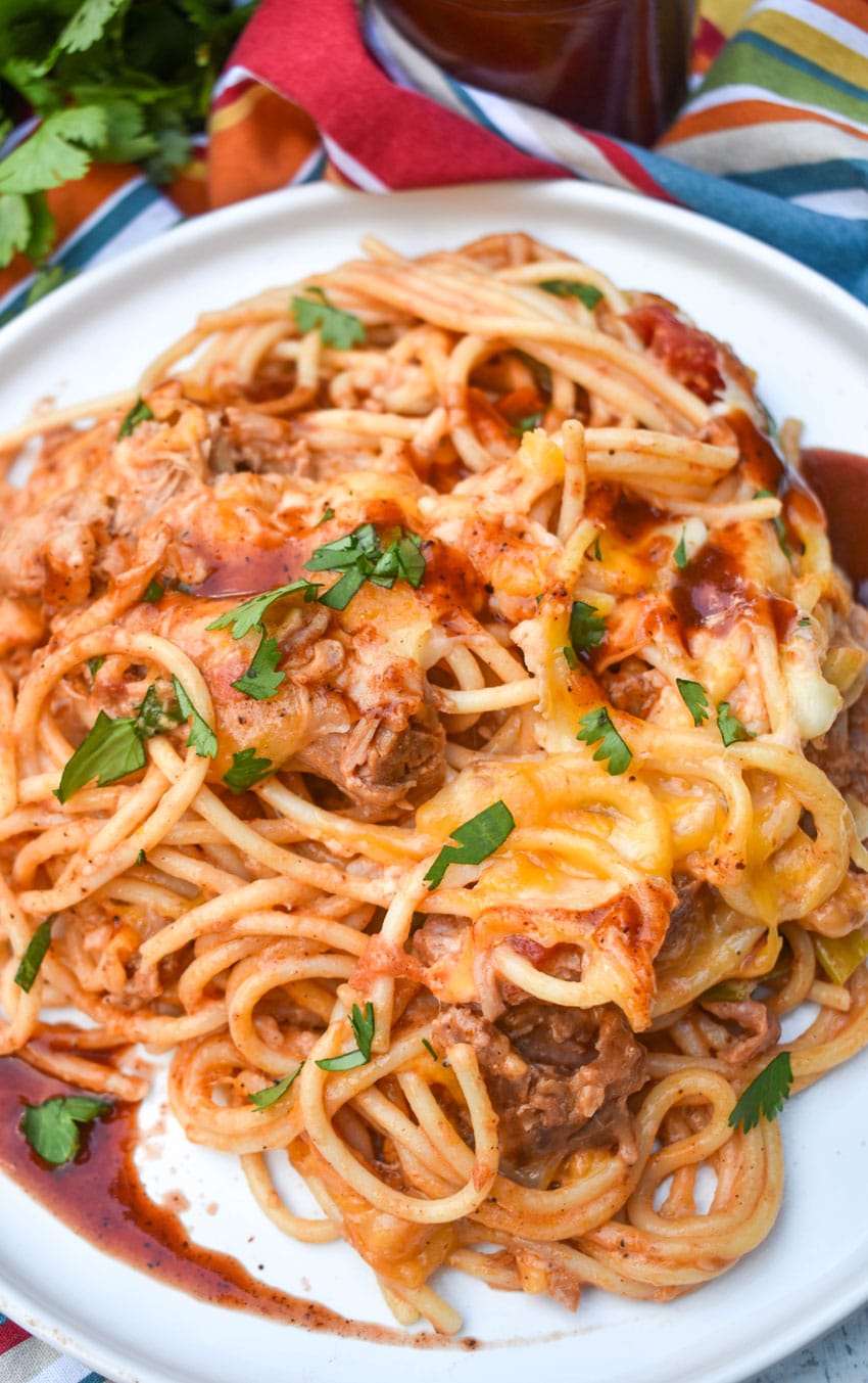 cheesy barbecue pulled pork pasta on a white plate