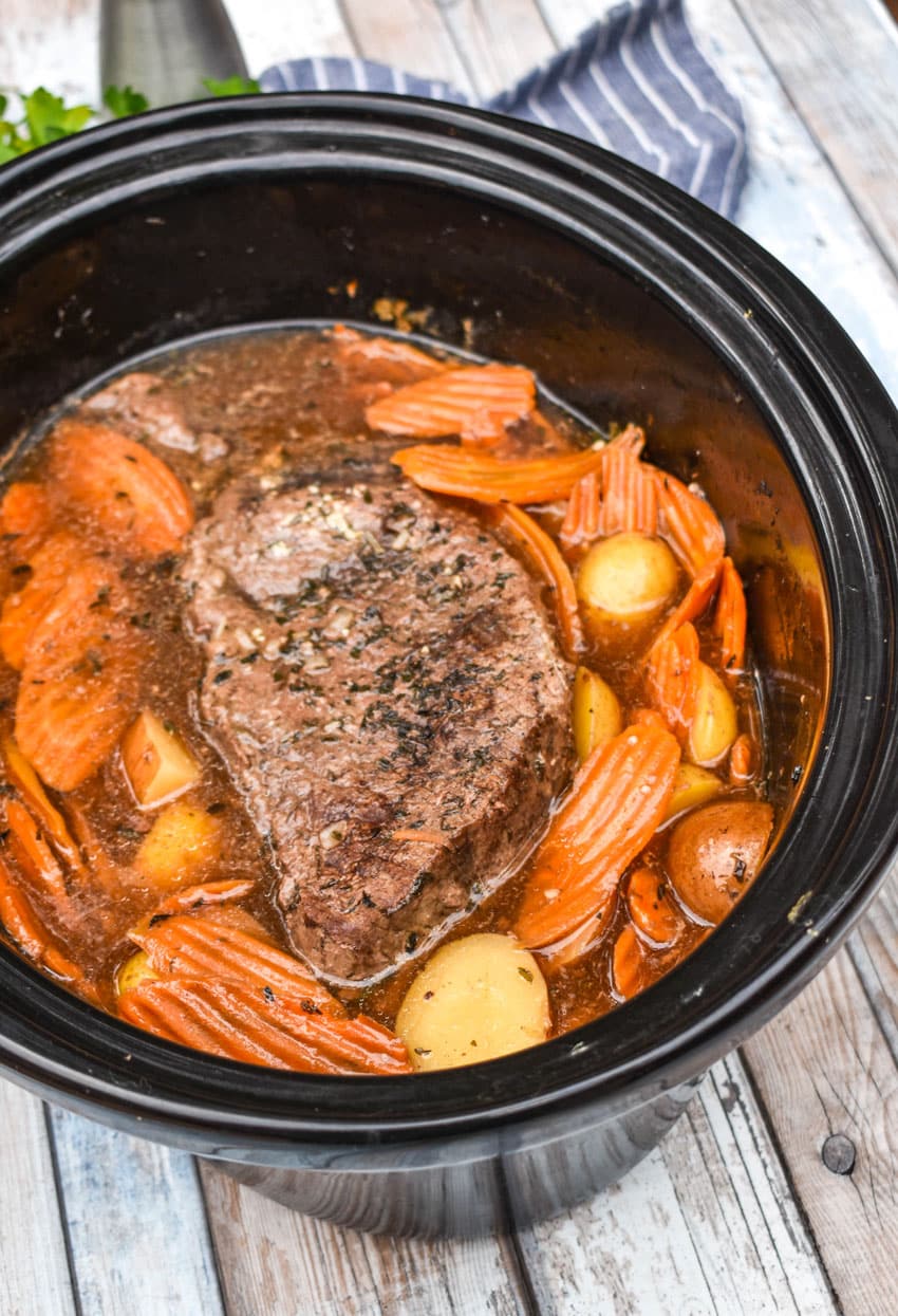 THE BEST SLOW COOKER POT ROAST RECIPE IN THE BOWL OF A BLACK CROCK