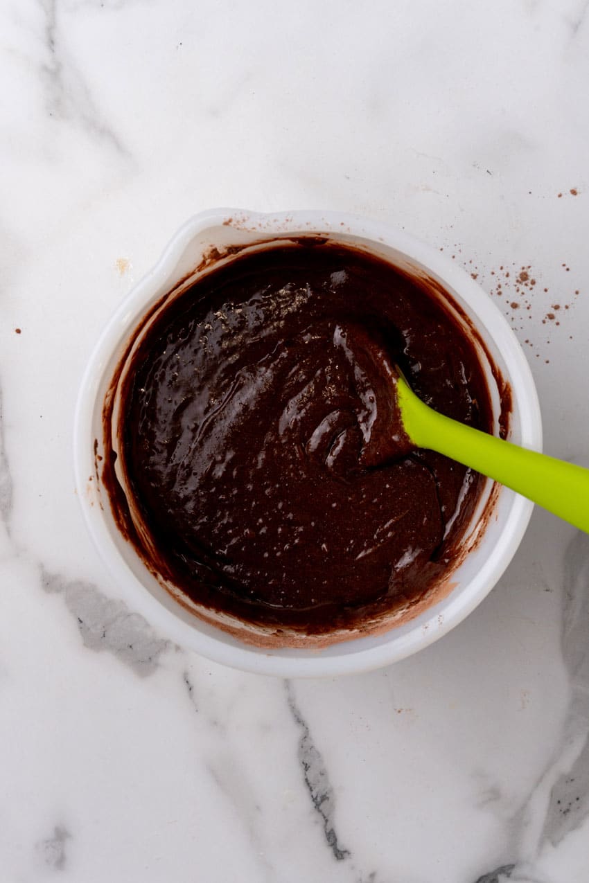 brownie batter in a white mixing bowl