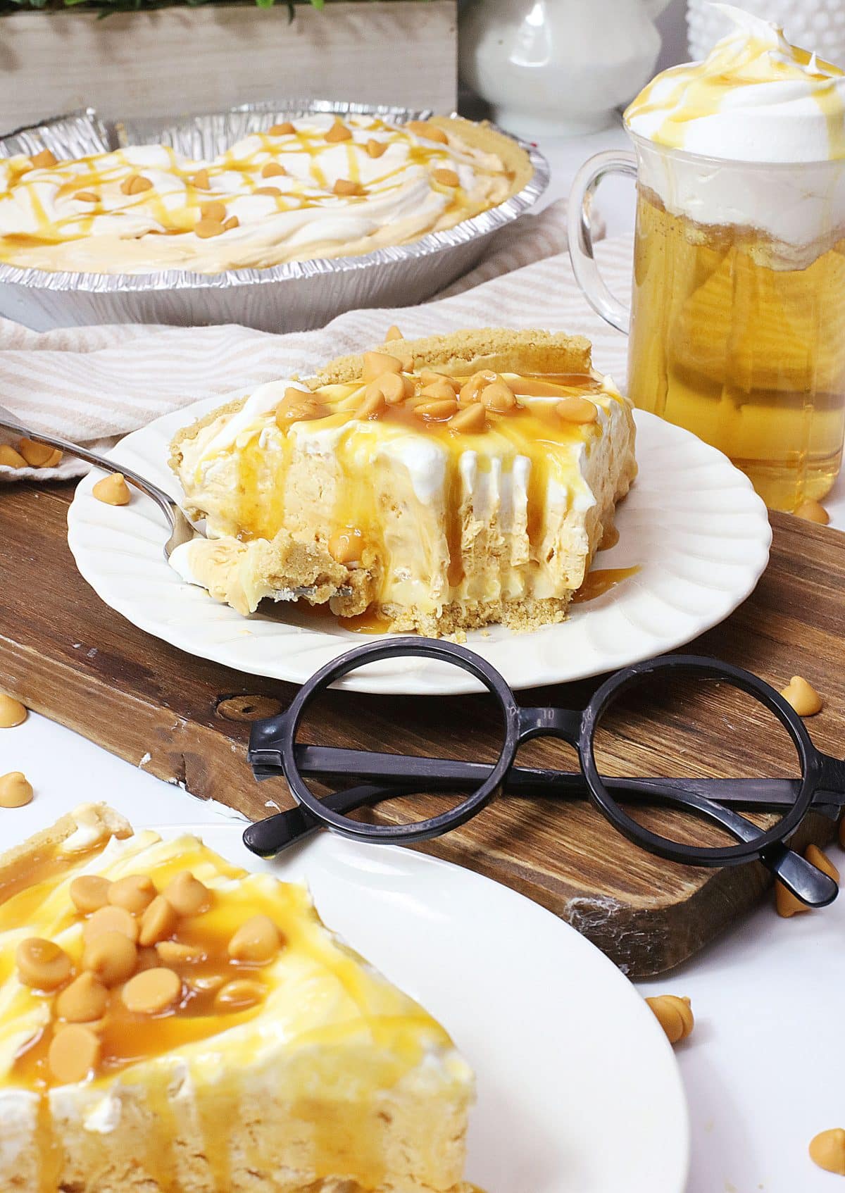 a slice of butterbeer pie topped with caramel sauce on a small white plate