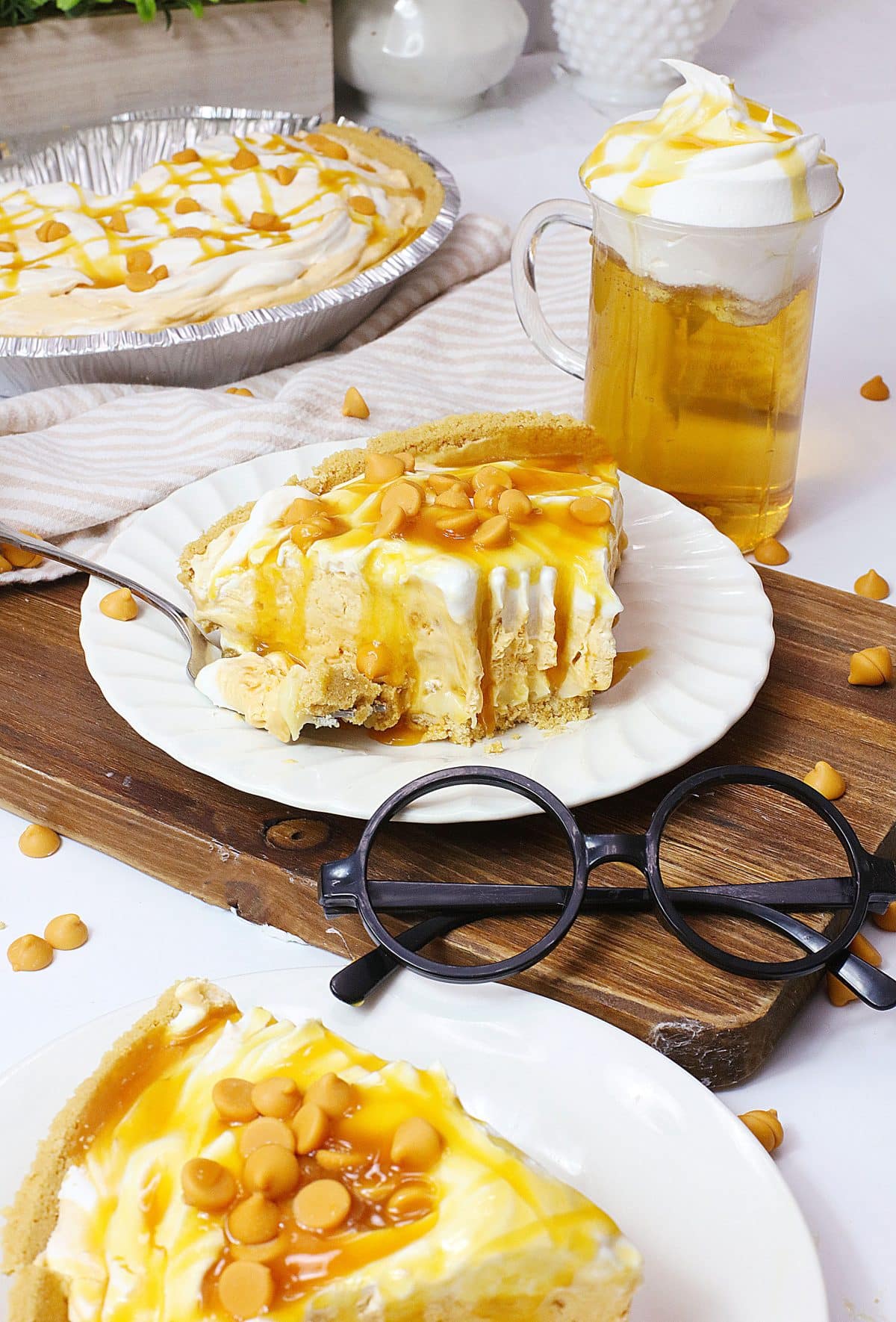 a slice of butterbeer pie topped with caramel sauce on a small white plate