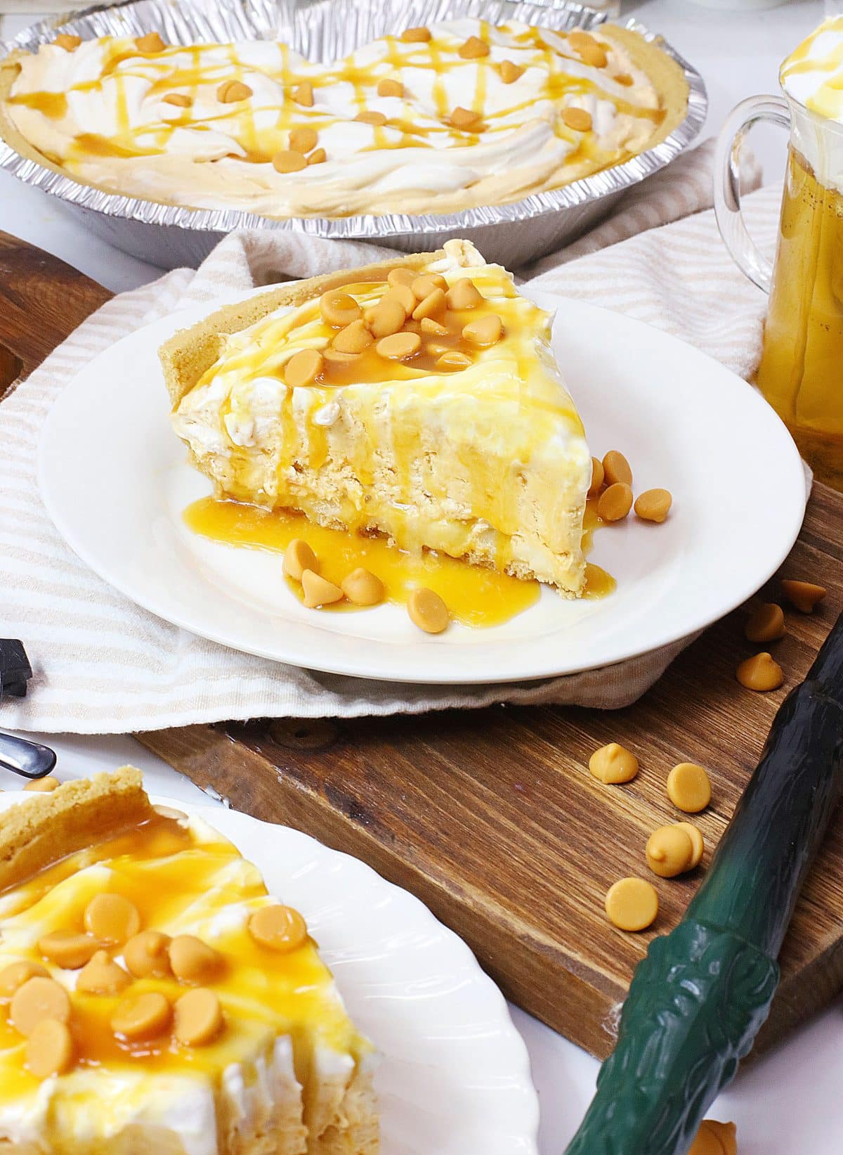 a slice of butterbeer pie topped with caramel sauce on a small white plate