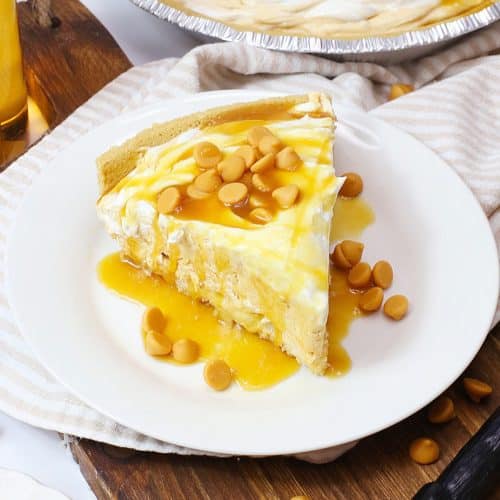a slice of butterbeer pie topped with caramel sauce on a small white plate